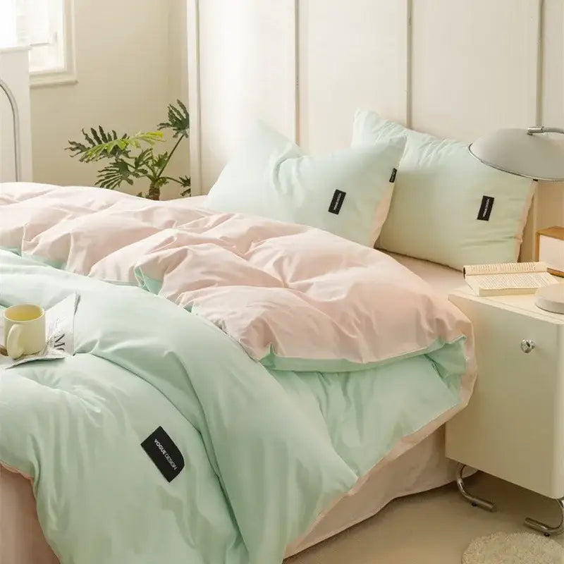 Soft cream cotton bedding set featuring pastel pink and mint green quilted duvet with black decorbites cotton bedding tags