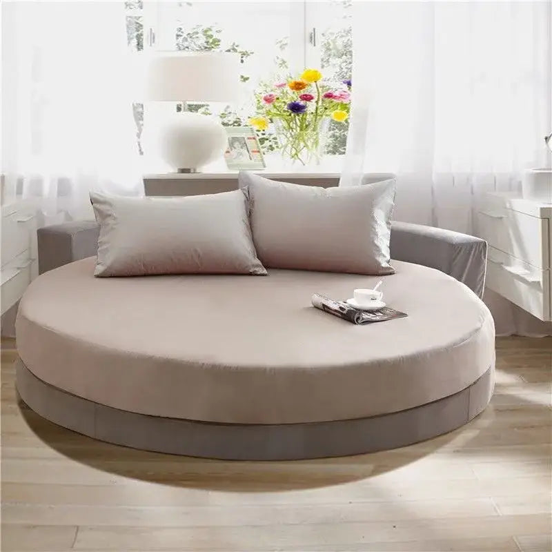 Beige round daybed with plush cushioning and matching pillows featuring a soft fabric decorbites cotton round bed sheet set