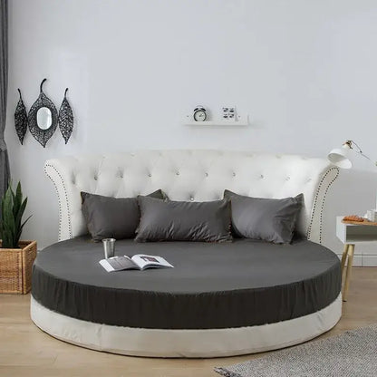 Round bed with tufted white headboard and soft dark gray decorbites cotton round bed sheet set in cotton round bedding