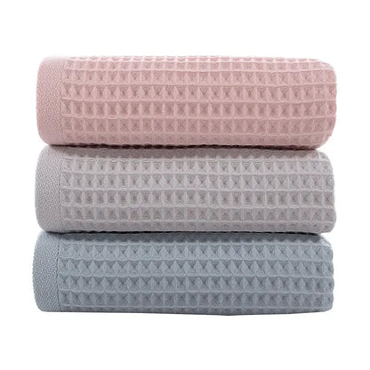 Soft gray blush and blue cotton waffle towels stacked neatly showcasing decorbites cotton waffle towel bath set