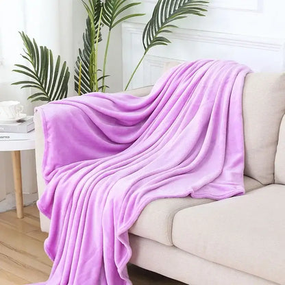 A soft lavender plush throw blanket draped over a beige sofa showcasing decorbites cozy flannel warm blanket