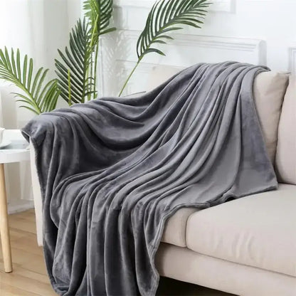 A plush soft gray flannel warm blanket draped over a beige sofa for cozy decorbites cozy flannel decor