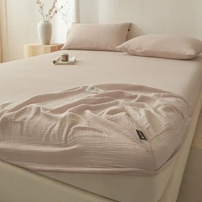 Soft light pink decorbites cotton fitted sheet with subtle textured weave and fabric tags for bedroom bed cover