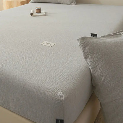 Soft light gray cotton fitted sheet with subtle woven pattern and white label for bedroom decorbites cotton fitted use