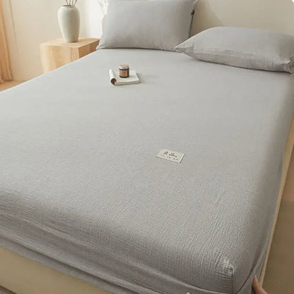 Soft light gray cotton fitted sheet with subtle woven pattern and stitched white label using decorbites cotton fitted design