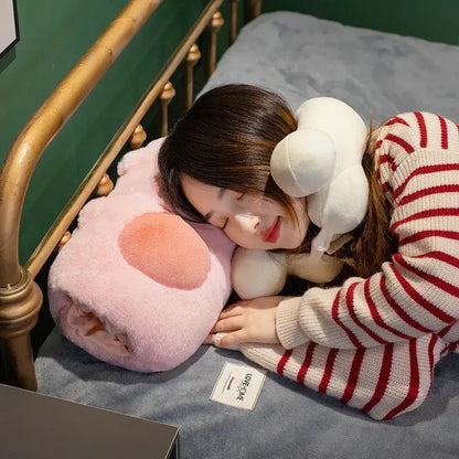 Soft pink cartoon pork plush heating pad shaped like pork doll throw wrapped around person sleeping on bed
