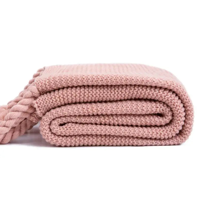 Soft pink decorbites knit throw blanket with ribbed texture and braided tassel accent for bedroom decor