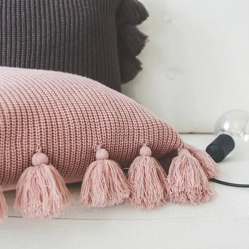 Soft pink knit cushion cover with fluffy tassels, a decorbites knit cushion perfect for living room decor
