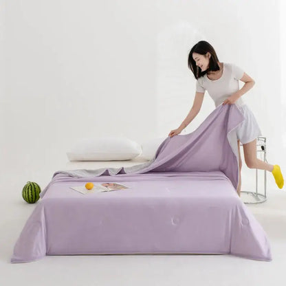 Lavender-colored satin bed sheet with subtle sheen complements soft teal and gold decorbites cool fibre summer quilt