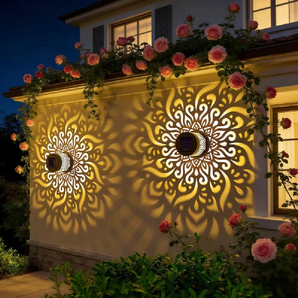 Two ornate circular solar mandala projection lights with floral cutouts casting warm golden patterns on beige wall