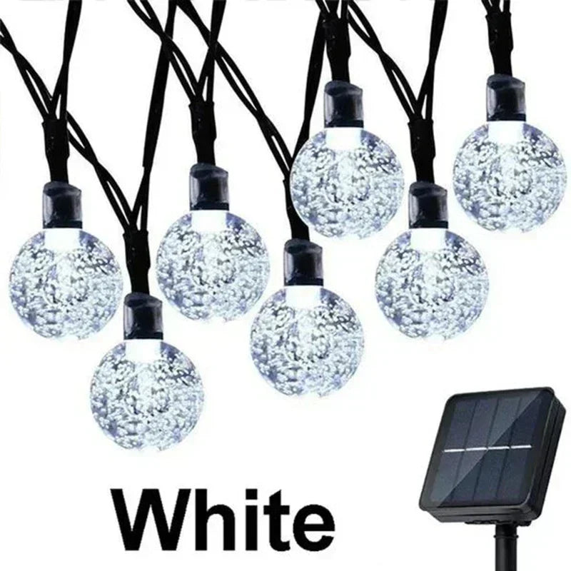 White solar string lights with clear bubble glass bulbs and black wiring for outdoor garden party decor