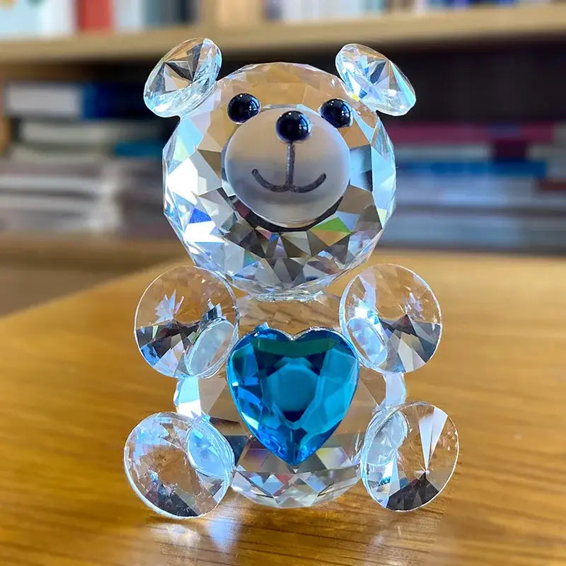 A sparkling decorbites crystal bear figurine with a blue heart and black bead eyes for bedroom decor