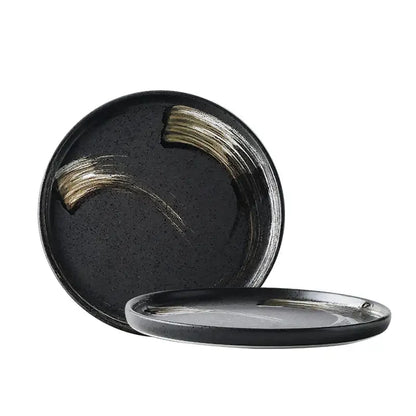 Black ceramic round dinner plate with elegant gold brushstroke accents from decorbites ceramic round collection