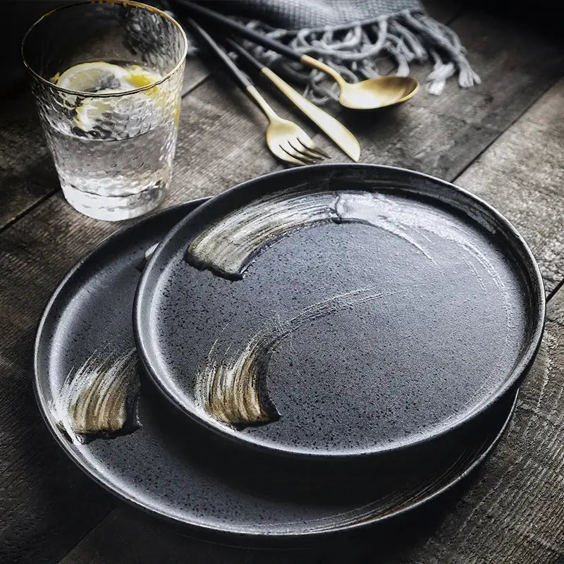 Dark gray ceramic round dinner plate with subtle gold brushstroke accents from decorbites ceramic round collection