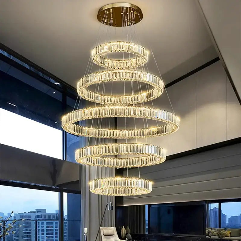 A decorbites crystal chandelier pendant light featuring multi-tiered spiral crystal rings with a gold ceiling mount