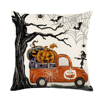Halloween pumpkin linen cushion cover featuring an orange vintage truck with pumpkins against black tree branches and spiderwebs