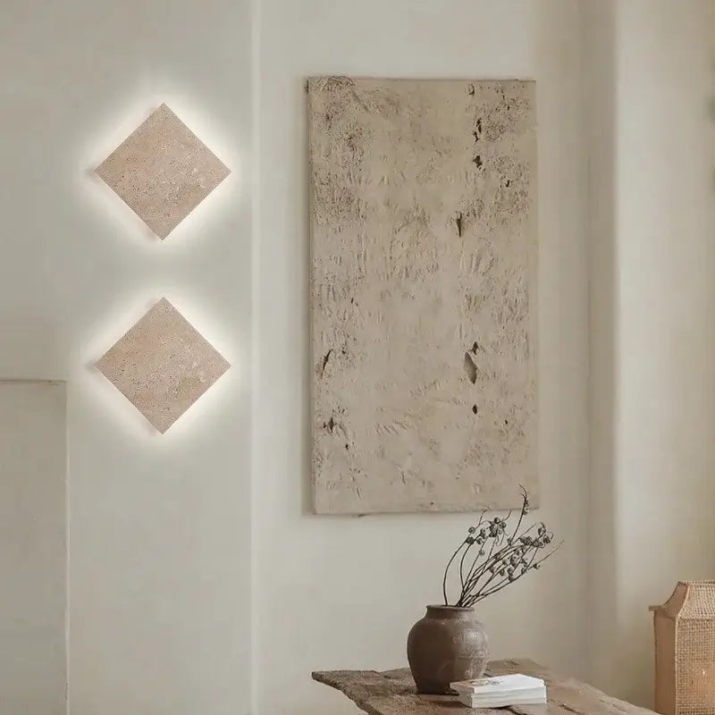 Two square beige travertine led wall lamp sconces with stone texture designed for stairways lighting