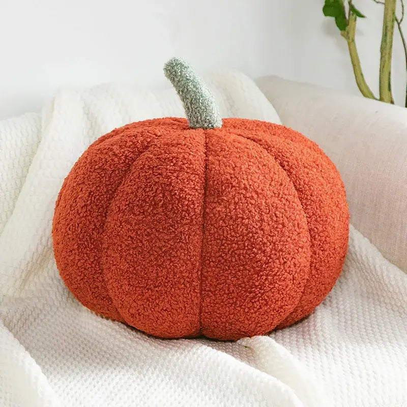 A plush orange fleece throw pillow shaped like a 3d pumpkin with a gray stem perfect for decorbites pumpkin decor