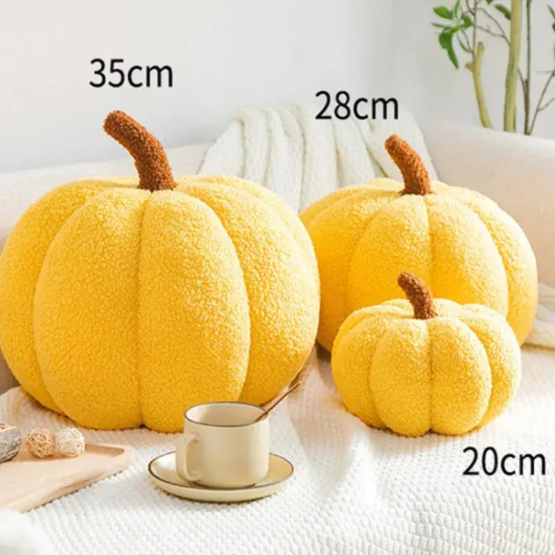 Three plush yellow pumpkin throw pillows in varying sizes with brown stems made of soft fleece decorbites 3d pumpkin decor