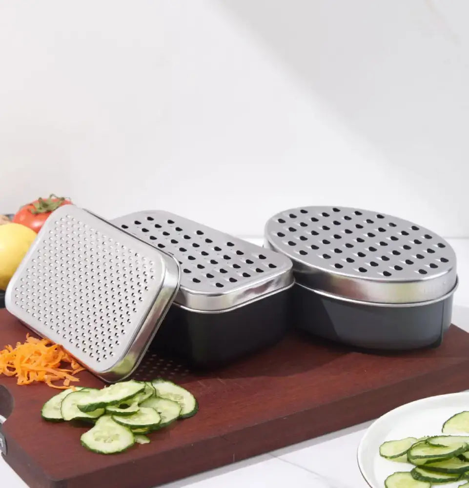 Stainless steel cheese grater with perforated surface and black container lid for kitchen use