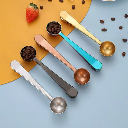 Set of four stainless steel coffee spoons and sealing clips in gold, rose gold, teal, and silver finishes