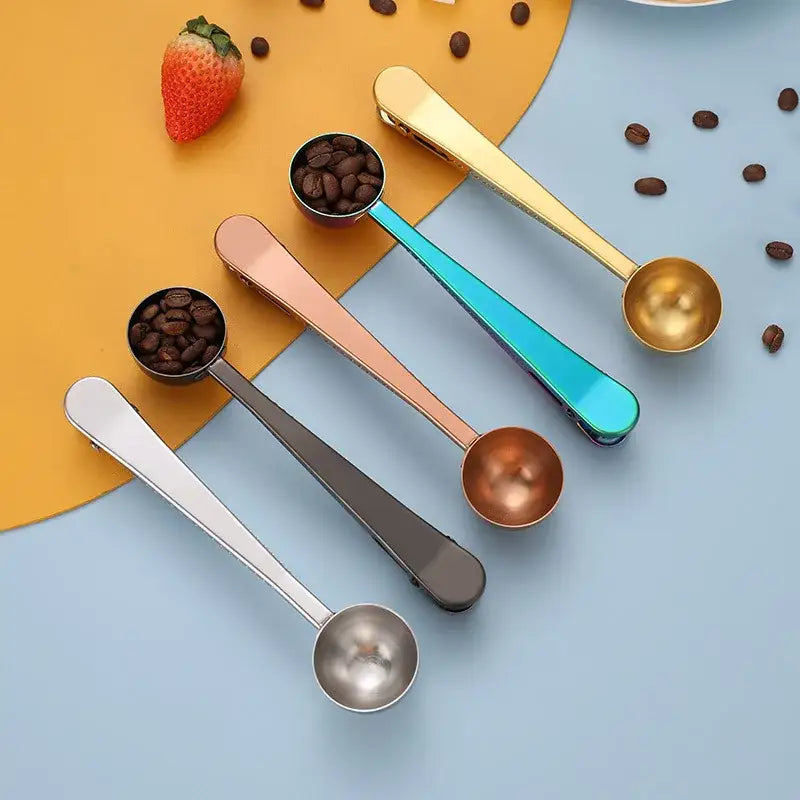 Set of four stainless steel coffee spoons and sealing clips in gold, rose gold, teal, and silver finishes
