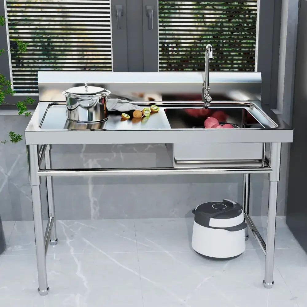Stainless steel commercial kitchen sink with single basin, left platform, high backsplash, and integrated faucet