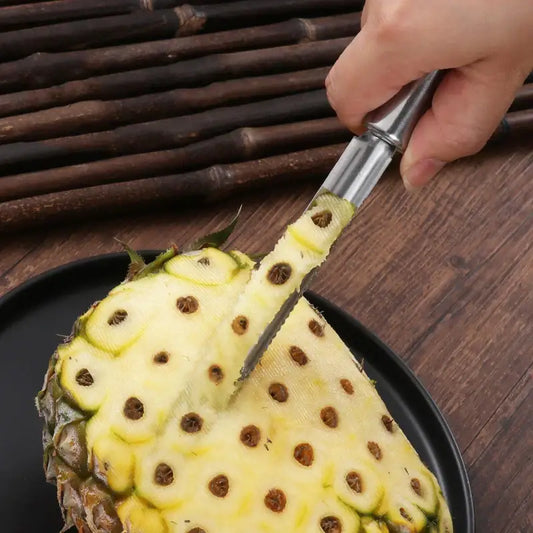 A stainless steel decorbites fruit corer with a sleek handle is used to core and slice a halved yellow pineapple