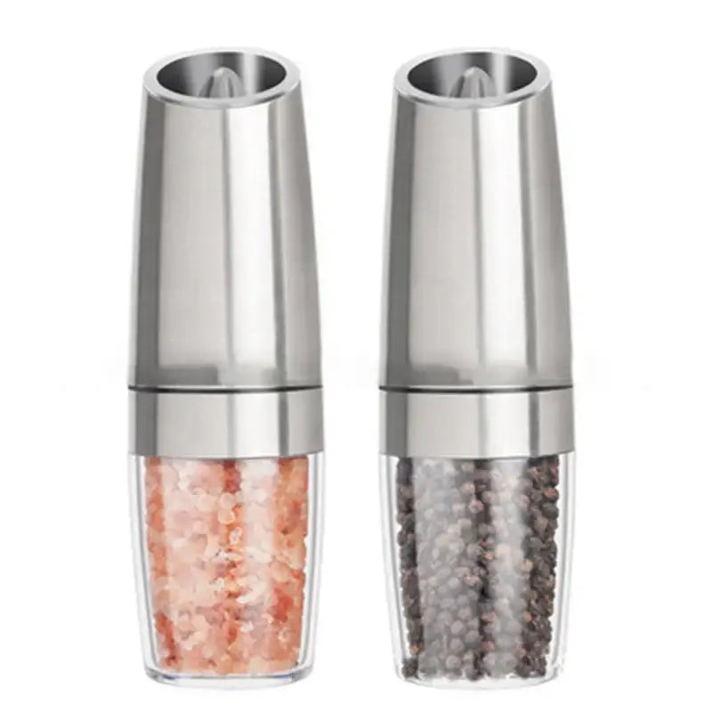 Stainless steel electric spice pepper grinder set with clear glass bases containing pink himalayan salt and black peppercorns kitchen accessory