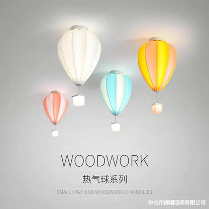 Striped fabric hot air balloon lamp in white, yellow-orange, and pastel blue-pink for kids bedroom decorbites hot air balloon lighting