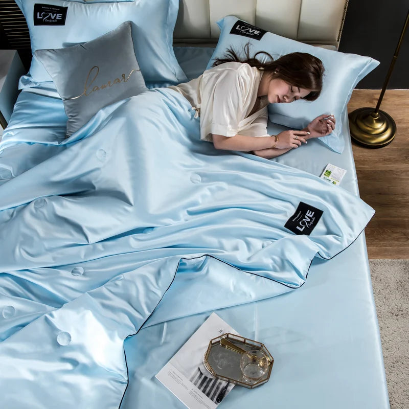 Light blue satin summer mulberry silk comforter duvet insert with subtle sheen and black trim accents queen size