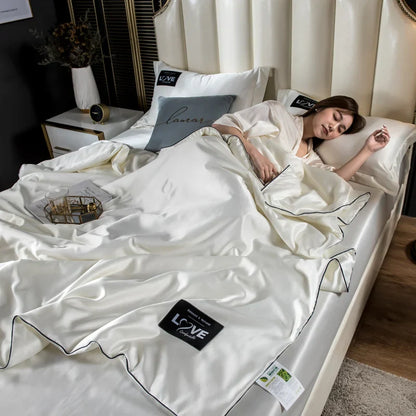 Cream-colored satin summer mulberry silk comforter duvet insert with black piping and love branded patch