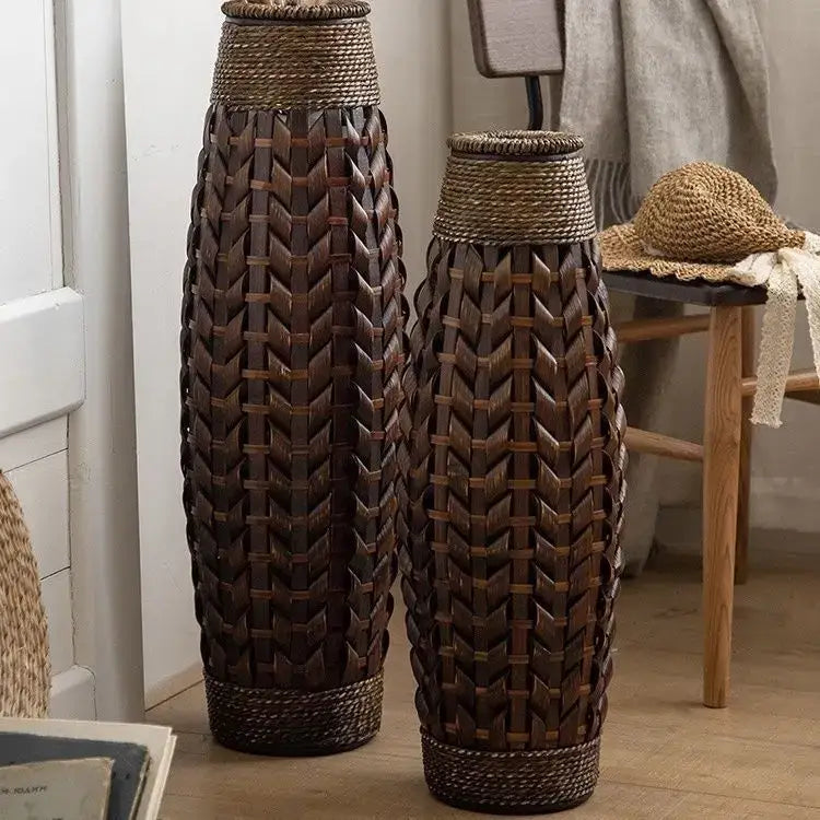 Two tall dark brown bamboo woven vases with herringbone pattern and natural fiber tops for living room decor