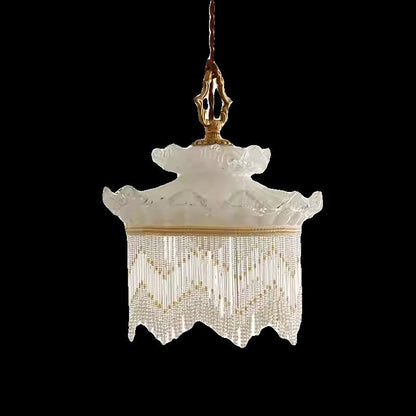 Cream-colored tassel chandelier with beaded main material and brass accents for dining room bedroom or hallway use