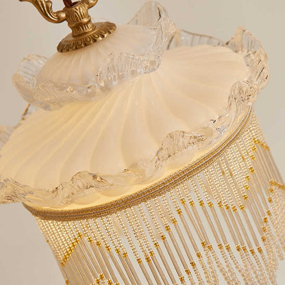 Vintage-style tassel chandelier with cream lace lampshade and clear glass base for dining room use