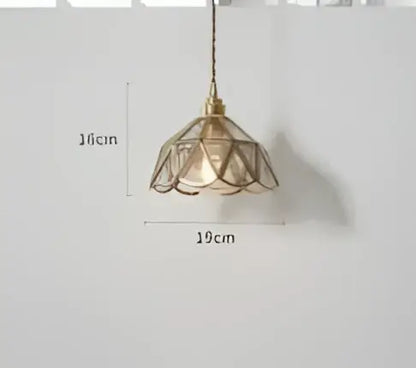 Teal blue glass pendant light with brass hardware and delicate lace-like petal shade for dining room decorbites blue glass