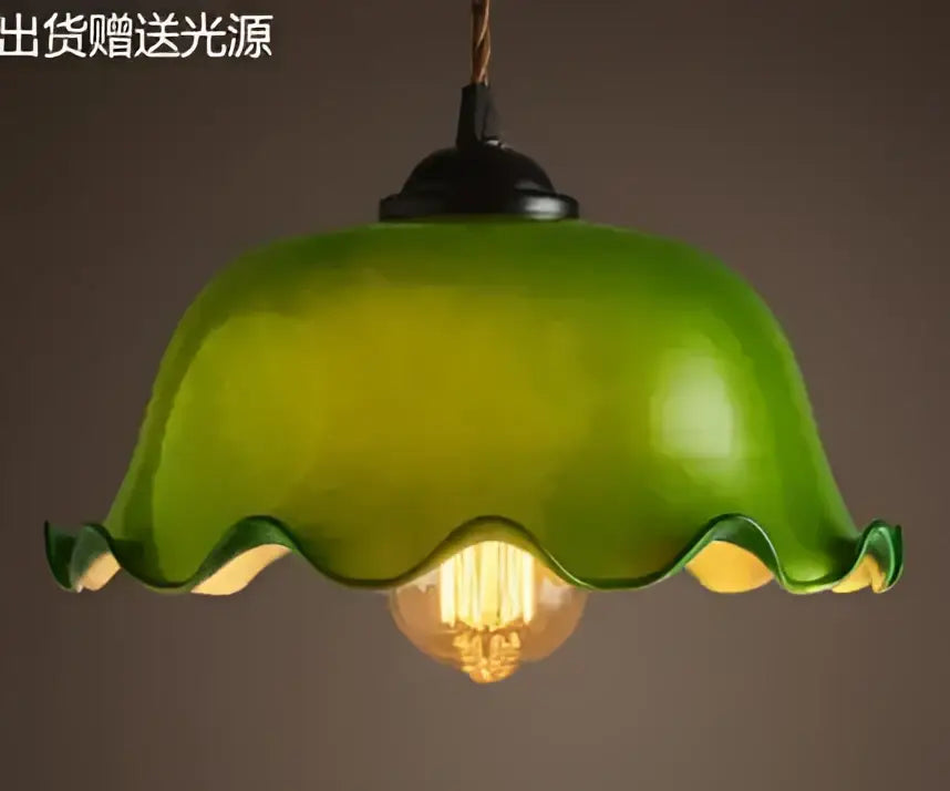 Teal blue glass pendant light with brass hardware featuring a green wavy glass pendant and exposed filament bulb for dining room decorbites blue glass pendant lights