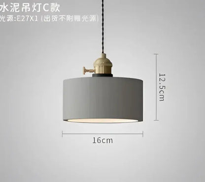 Gray cylindrical pendant light with brass-finished metal fixture and black cord complements decorbites blue glass pendant lights