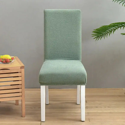 A mint green textured stretch chair cover with a subtle grid pattern by decorbites blue quilted chair cover protector
