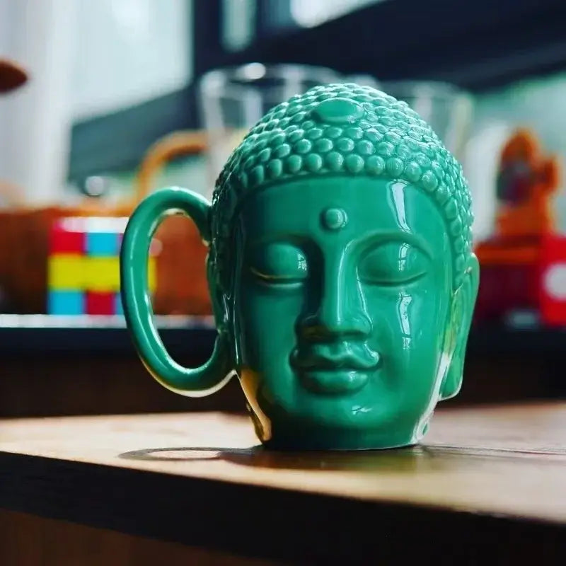 Teal buddha sculpture ceramic coffee mug with detailed facial features and curved handle by decorbites for kitchen decor