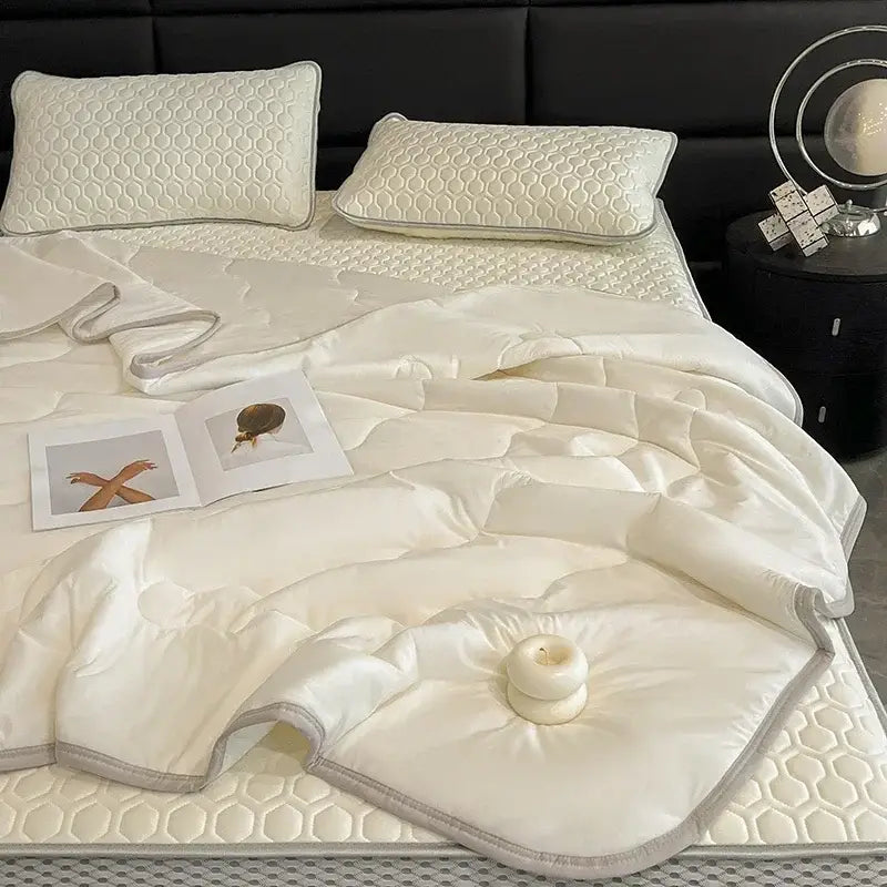 Cream-colored quilted comforter with honeycomb texture and satin finish in teal and cream decorbites cool summer blanket set