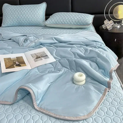 Teal and cream zigzag cool summer blanket set featuring a light blue quilted bed set with satin finish decorbites cool summer