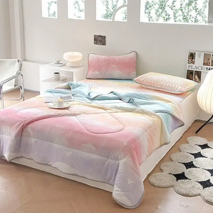 Pastel rainbow gradient quilt with soft cloud patterns and subtle stitching in teal and cream decorbites cool summer blanket set