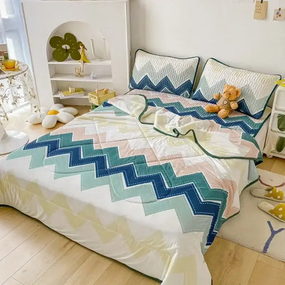 Quilted teal and cream zigzag cool summer blanket set in shades of blue teal and peach on white base for decorbites