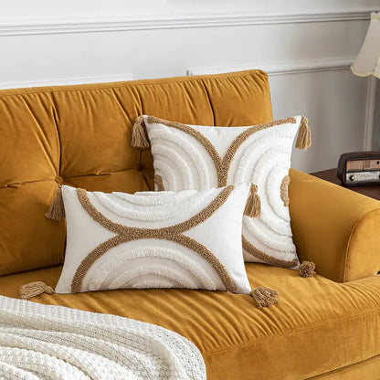 White rectangular decorbites boho tufted pillow covers with beige embroidery and tassels on mustard yellow velvet sofa