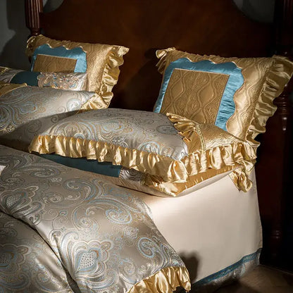 Luxurious teal and gold embroidered bedding set in 200s egyptian cotton with intricate paisley patterns and ruffled edges