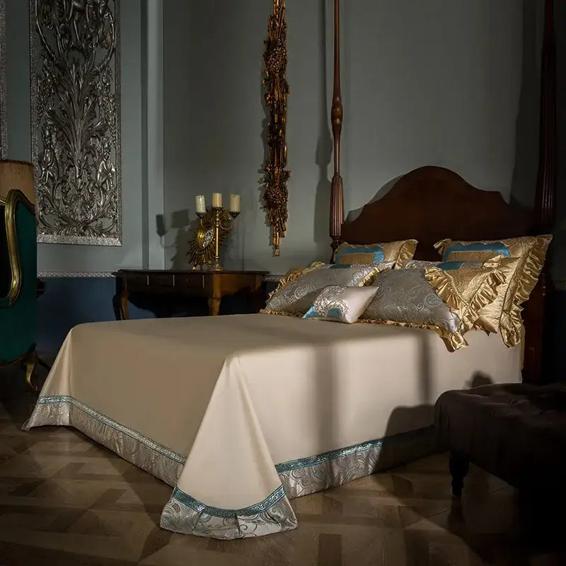 Cream-colored satin bedspread with silver and teal embroidered trim in teal and gold embroidered 200s egyptian cotton bedding set