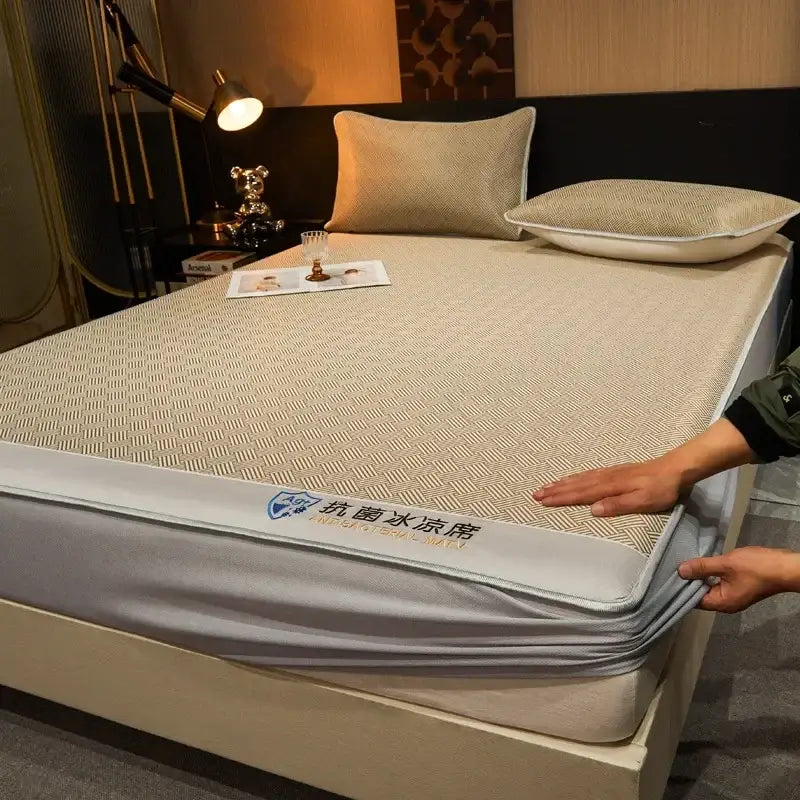 Beige textured antibacterial cooling mattress pad with gray elastic border paired with teal silky soft fitted sheet set