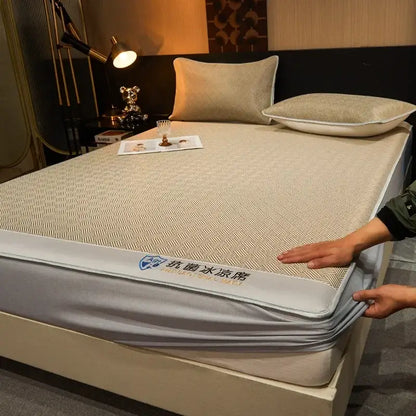 Beige textured antibacterial cooling mattress pad with gray elastic border paired with teal silky soft fitted sheet set