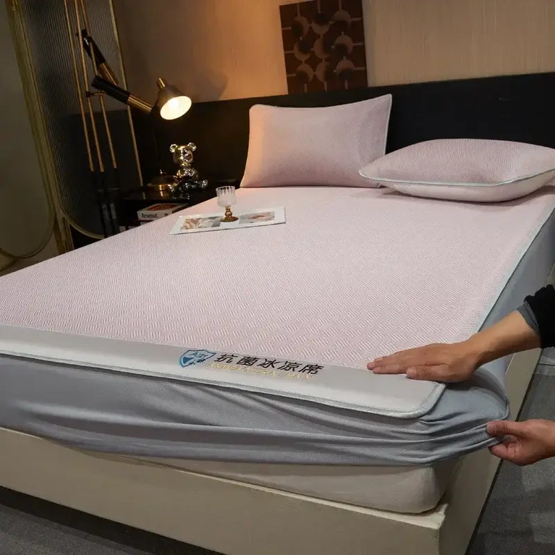 Light pink textured silky soft fitted sheet pad with gray elastic border and Chinese text logo for bedroom bedding